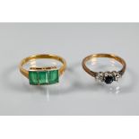 A three stone diamond and sapphire ring, size K and a three stone green paste set ring, 18ct and