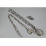 Two Victorian silver oval lockets on chains, one with Gothic style pierced links, the other