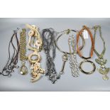 An assortment of modern costume jewellery necklaces including gilt metal, leather corded pendants,