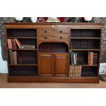 A Victorian mahogany low open bookcase, centred by two long drawers over an open niche and pair