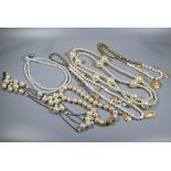 Simulated pearl necklaces of varying designs including chain linked, oversize beads, gilt metal