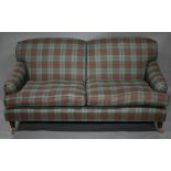 A contemporary pale green / red chesk patterned two seat sofa, on turned mahogany legs to brass