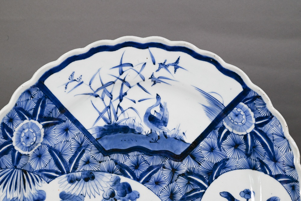 A 19th century Japanese blue and white floriform charger, painted with a goose and bamboo within a - Image 2 of 10