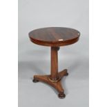 A Victorian rosewood occasional table, the circular top raised on a tapering turned pillar to a