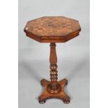 A Victorian octagonal chess board inlaid games table, raised on a turned support to quad platform