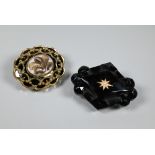 Two Victorian mourning brooches - a diamond-shaped jet brooch with inset gold star motif with seed