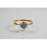 A small antique daisy cluster ring set with seven small diamonds, 18ct yellow gold set, size M 1/