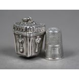 A Victorian thimble-case of square tapering form with embossed decoration, hinged cover with