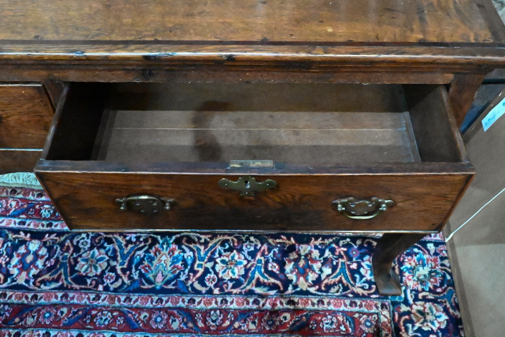 An 18th century cross-banded oak low dresser, with three cock-beaded frieze drawers over a wavy - Image 5 of 5