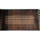 A North East Persian Turkoman rug, camel ground, 224 cm x 124 cm