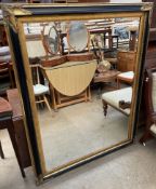 A large modern gilt and ebonised wall mirror of rectangular form