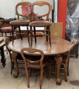 An early 20th century mahogany extending dining table together with a set of six Victorian Balloon