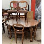 An early 20th century mahogany extending dining table together with a set of six Victorian Balloon