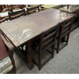 An 18th century style oak refectory table with a planked rectangular top on turned baluster columns,