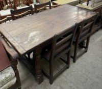 An 18th century style oak refectory table with a planked rectangular top on turned baluster columns,