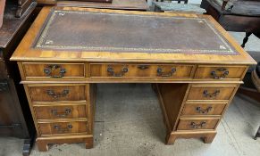 A 20th century yew wood pedestal desk