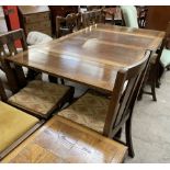 A 20th century oak drawleaf dining table together with a set of four dining chairs