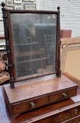 A 19th century mahogany toilet mirror with a rectangular plate and ring turned supports,