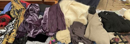 A quantity of lady's clothing including Ann Harvey trousers, lambswool ponchos,