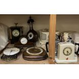 A black slate mantle clock together with three other clocks,