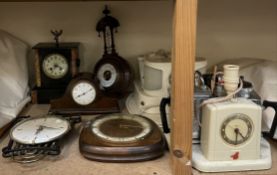 A black slate mantle clock together with three other clocks,