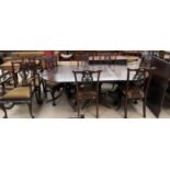 A George III style mahogany dining suite comprising an extending dining table and eight chairs