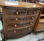 A Victorian mahogany chest with a D shaped top above two short and three long drawers on turned