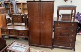 A Stag bedroom suite comprising a chest of drawers, dressing table stool, dressing table,