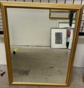 A gilt framed wall mirror of rectangular form with a bevelled plate