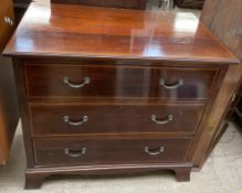 An Edwardian mahogany chest of rectangular form with three long drawers on bracket feet