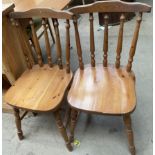 A pair of pine kitchen chairs together with a pine kitchen table
