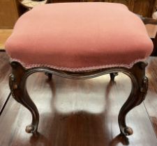 A continental mahogany stool with a shaped pad upholstered seat on scrolling legs