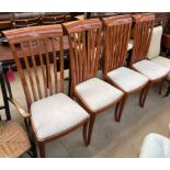 A set of four modern stick back dining chairs