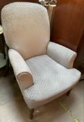 A Victorian style nursing chair with an upholstered back and seat on turned legs