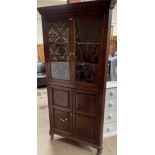 A 19th century oak standing corner cupboard, the moulded cornice above a pair of glazed doors,