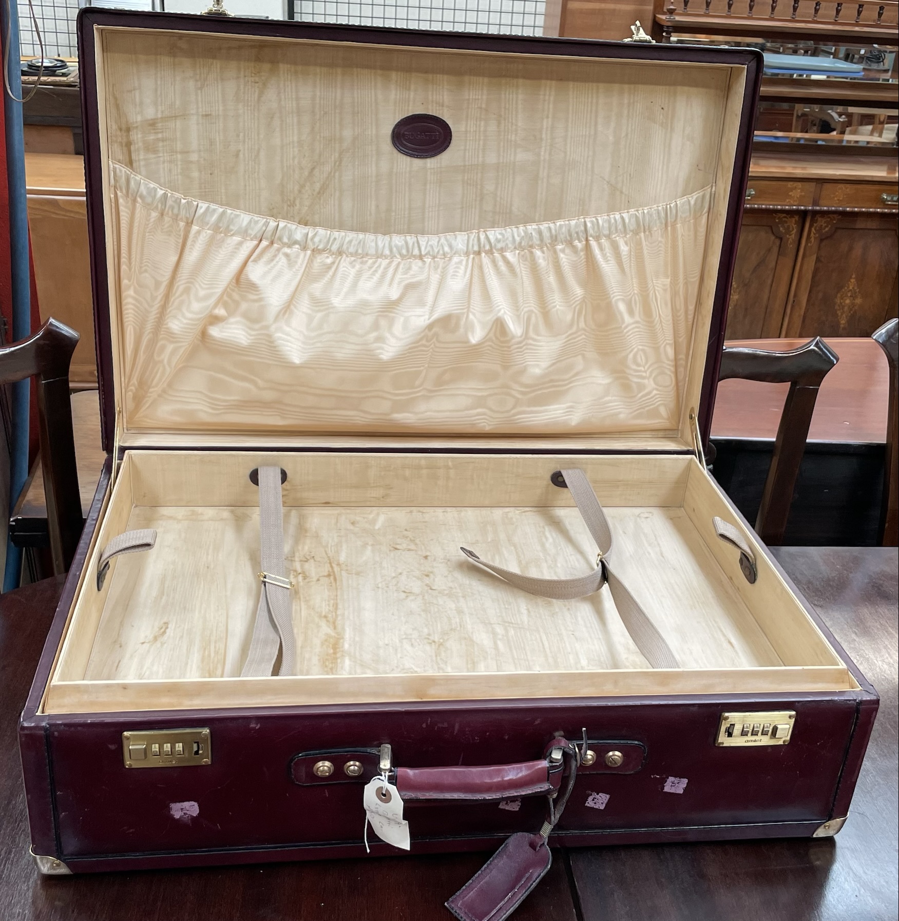 A Bugatti ox blood suitcase with brass corners