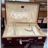 A Bugatti ox blood suitcase with brass corners