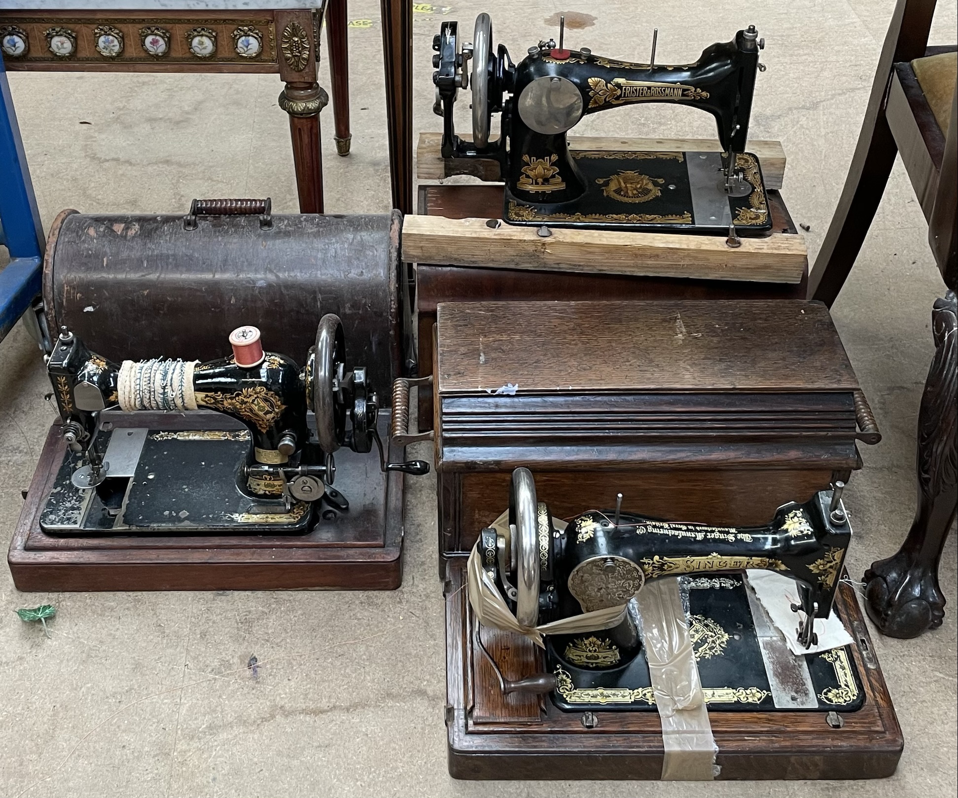 A Frister & Rossmann sewing machine and two singer sewing machines,