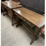 A 20th century oak side table with a rectangular top and a single drawer on stiles together with a