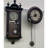 A postman's clock together with a Vienna regulator type clock