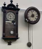 A postman's clock together with a Vienna regulator type clock