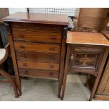 An early 20th century mahogany music cabinet with a rectangular top above five drawers on square