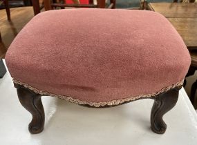 A small continental upholstered foot stool with a pad top on shaped legs
