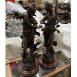 A pair of spelter figures of maidens playing musical instruments,
