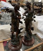 A pair of spelter figures of maidens playing musical instruments,