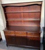 A Stag dresser with a moulded cornice above two shelves,