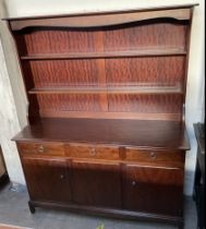 A Stag dresser with a moulded cornice above two shelves,