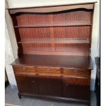 A Stag dresser with a moulded cornice above two shelves,