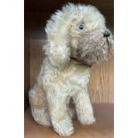 A mohair teddy bear in the form of a seated dog