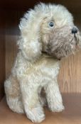 A mohair teddy bear in the form of a seated dog